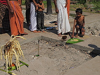 Food offerings to the departed soul - boy practices a Hindu memorial rite